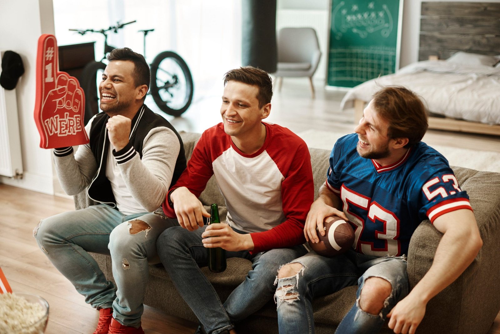 Men watching match at living room